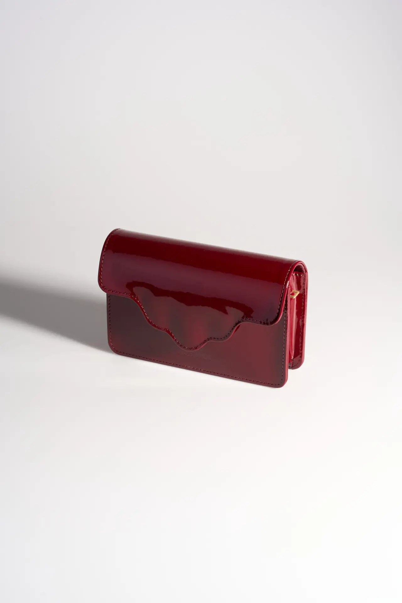 Burgundy patent crossbody, white ground
